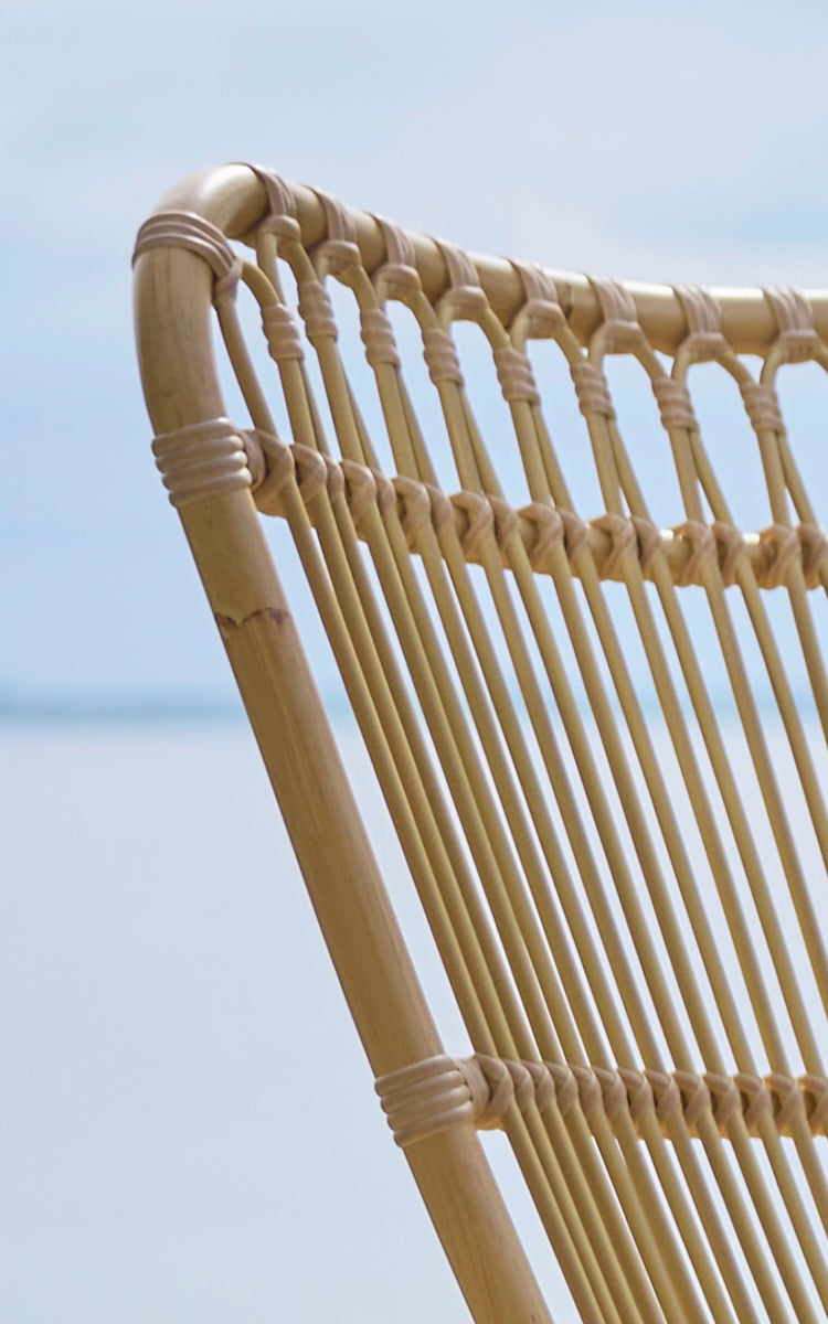 This is a close-up image of Monet Exterior Lounge Chair in natural aluminium artfibre. Detail of the looped arches and rod seat.