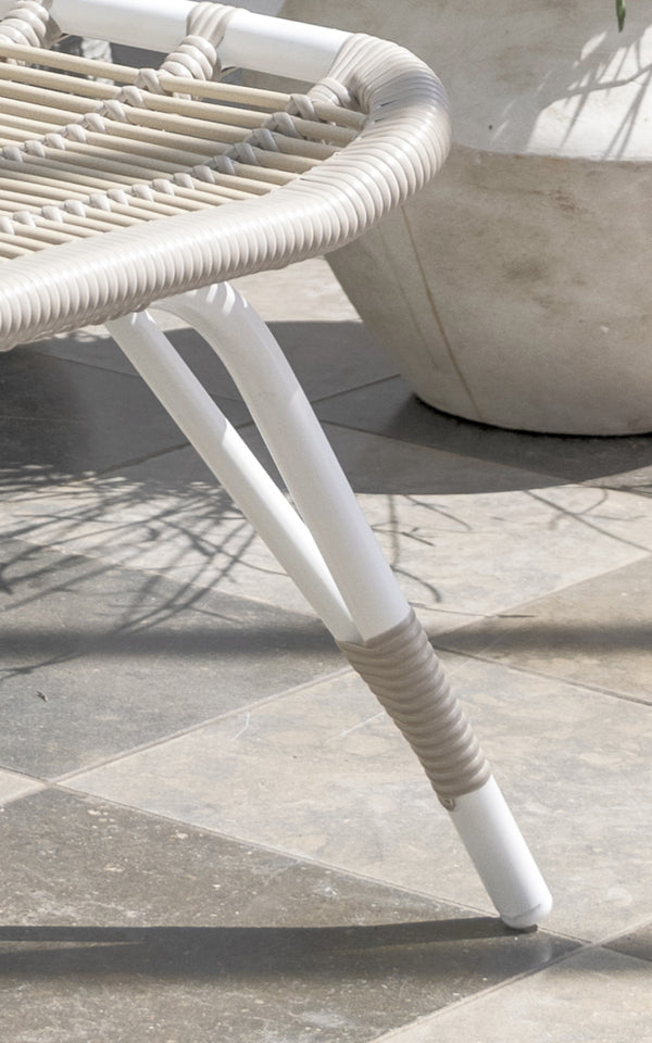 This is a close-up image of Monet Exterior Footstool in dove white aluminium artfibre. Detail of the woven seat and white frame.