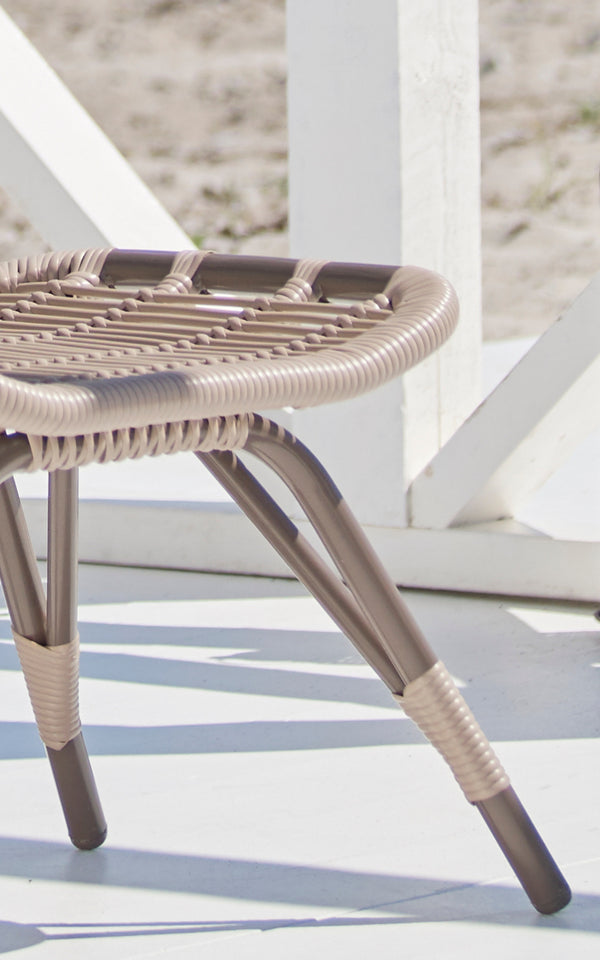 This is a close-up image of Monet Exterior Footstool in moccaccino aluminium artfibre.