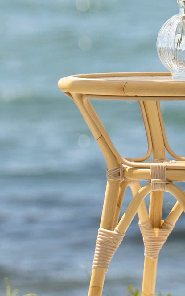 This is a close-up image of Tony Exterior Side Table in natural aluminium artfibre. Detail of the natural wrapped base and tripod leg joint.
