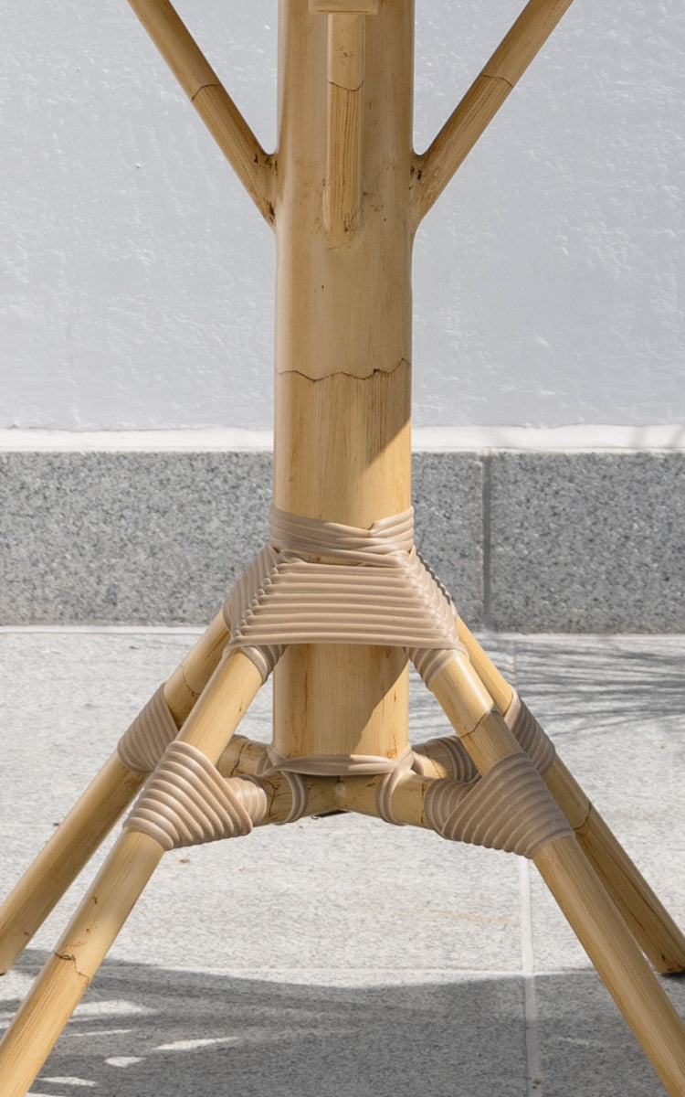 This is a close-up image of Nicole Cáfe Table Teak 70x70 cm in natural aluminium artfibre. Detail of the woven texture and frame construction.