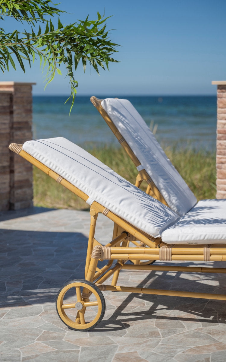 This is a close-up image of Julietta Double Sunbed in natural aluminium artfibre. Sunbed frame and wheels by the sea.