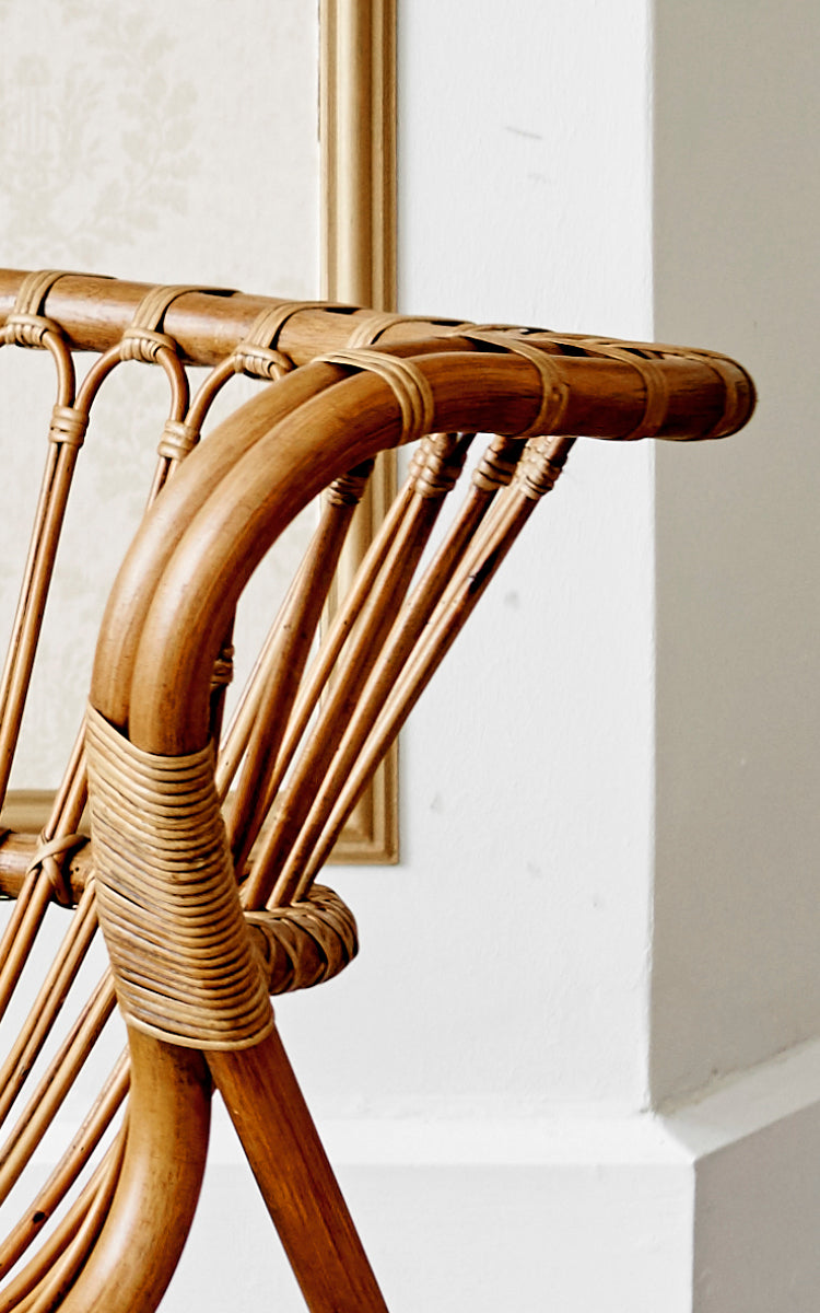 This is a close-up image of Fox Lounge Chair in polished Antique Rattan.