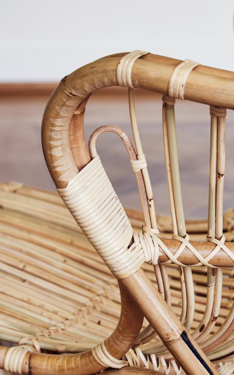 This is a close-up image of Fox Lounge Chair in polished Natural Rattan.
