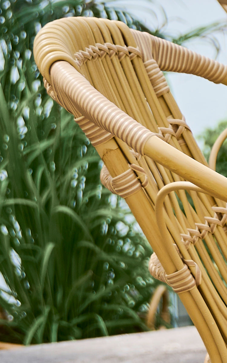 This is a close-up image of Robert Exterior Dining Chair in natural aluminium artfibre. Detail of the woven texture and frame construction.