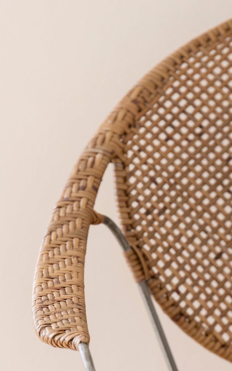 This is a close-up image of Funky Dining Chair in hazelnut rattan iron frame.