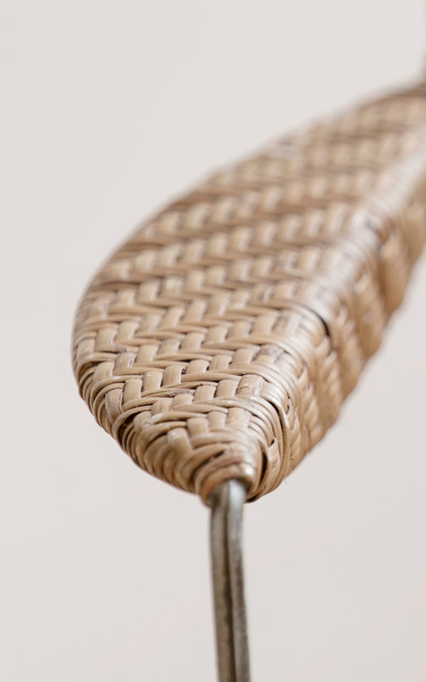 This is a close-up image of Rap Dining Chair in hazelnut rattan iron frame.
