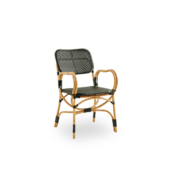Side view of Bistro chair in black ArtFibre weave with elegant design. Rattan frame with seat woven in ArtFibre. The curved Rattan frame under the seat extend into armrests.