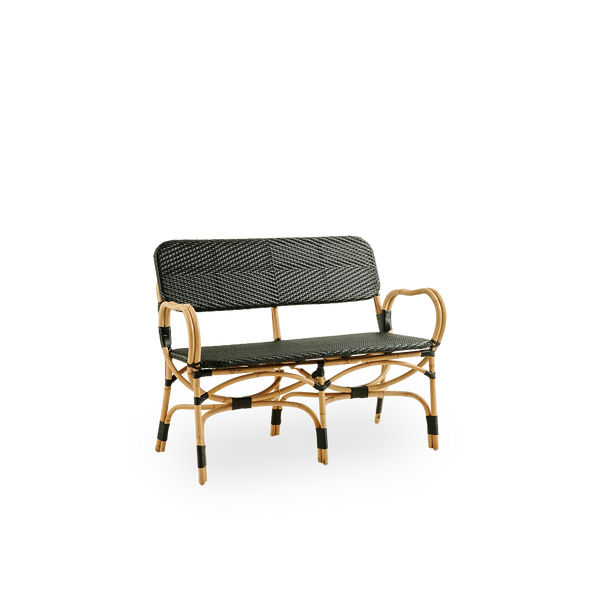 Side view of Bistro bench in black ArtFibre weave with elegant design. Rattan frame with seat woven in ArtFibre. The curved Rattan frame under the seat extend into armrests.