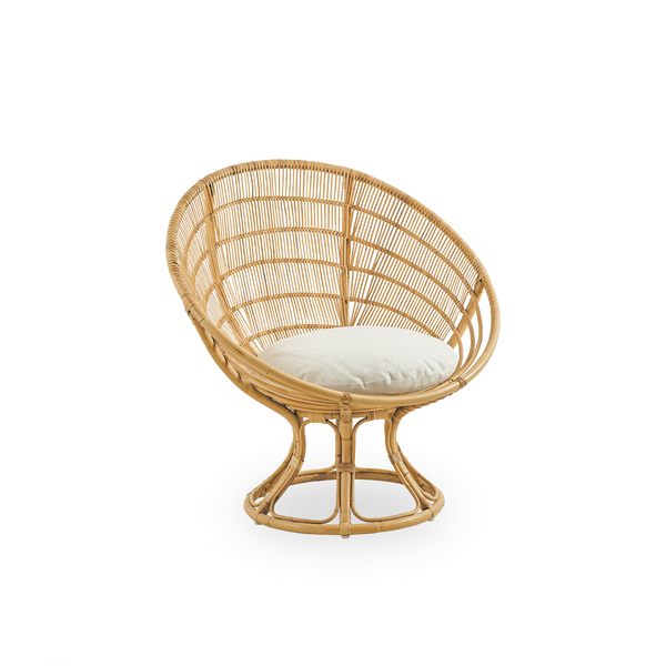Side view of Luna lounge chair designed by Franco Albini & Franca Helg. Round lounge chair with seat cushion, handcrafted in high quality rattan.