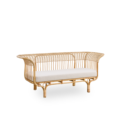 Side view of Belladonna sofa in natural rattan, designed by Franco Albini and Franca Helg. The sofa has an elegant expression with thin legs and a majestic seat with many detailed windings.