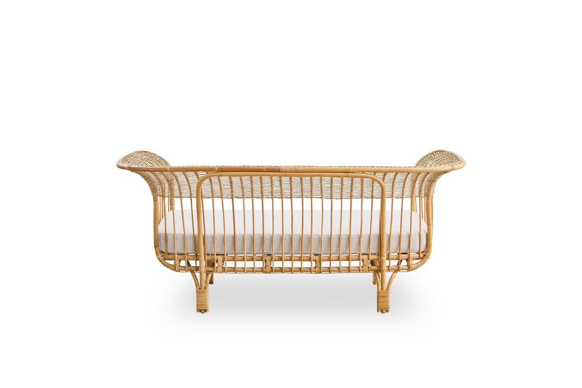 Plain back view of Belladonna sofa in natural rattan, designed by Franco Albini and Franca Helg. The sofa has an elegant expression with thin legs and a majestic seat with many detailed windings.