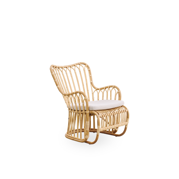 Side view of Tulip lounge chair designed by Tove Kindt-Larsen, with soft organic lines. Handcrafted from high-quality Indonesian rattan