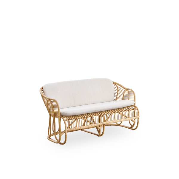 Side view of Swing 2-seater sofa designed by Tove Kindt-Larsen. Handcrafted from high-quality Indonesian rattan and fitted with seat and back cushion.