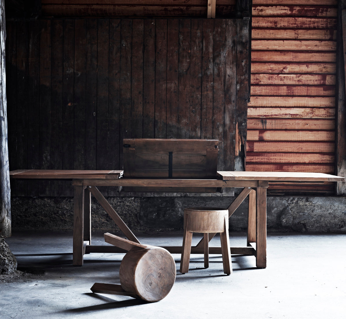 This is a lifestyle image of George Exterior Extendable Table 200(280) in outdoor Teak, on an outdoor garden patio with a white house facade and.
