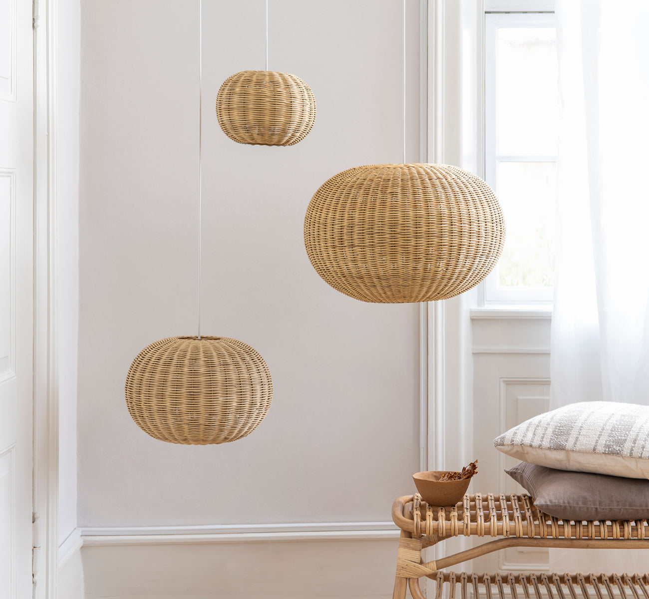 This is a lifestyle image of Tangelo Lampshade Ø24 cm | Extra Small in natural rattan. Styled in a bright interior setting.