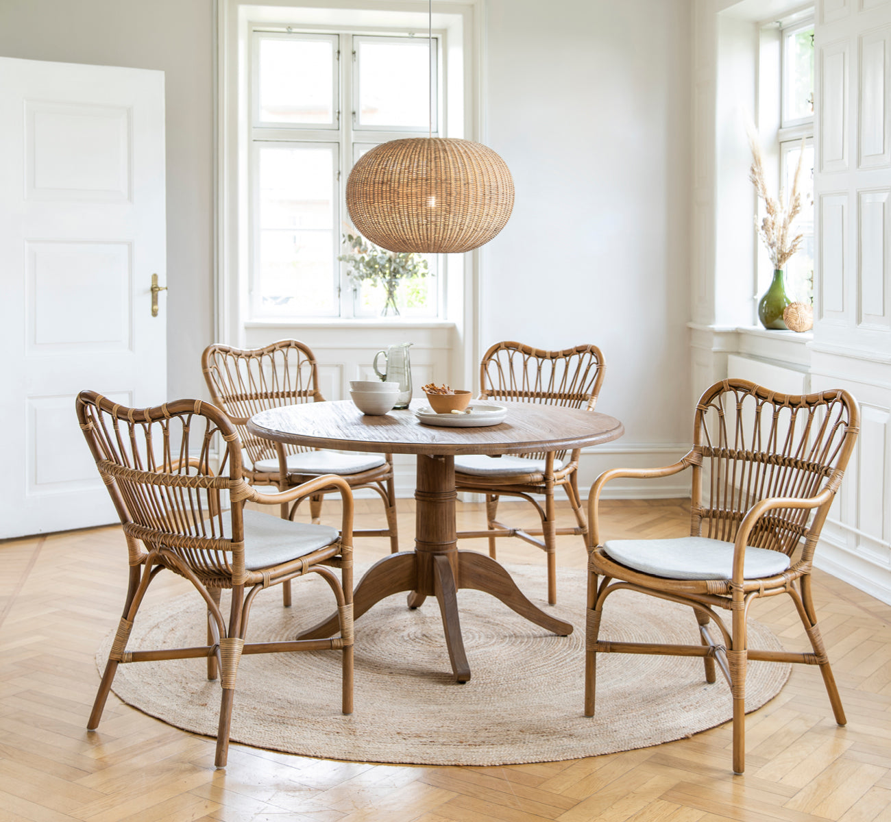 This is a lifestyle image of Tangelo Lampshade Ø62 cm | Large in natural rattan. Styled in a bright interior setting.