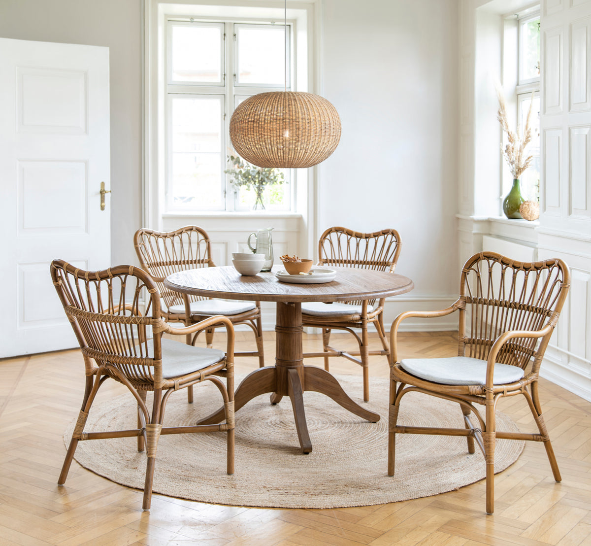 This is a lifestyle image of Tangelo Lampshade Ø62 cm | Large in natural rattan. Styled in a bright interior setting.