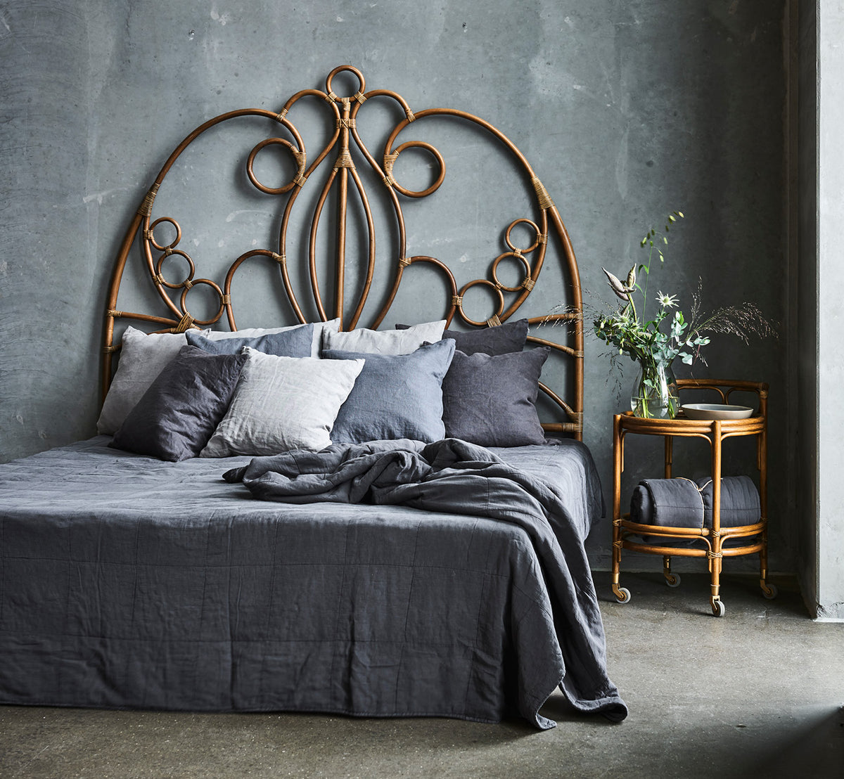 This is a lifestyle image of CTE058DB Bedspread in dusty Blue Cotton, in a serene bedroom with neutral decor and herringbone parquet.