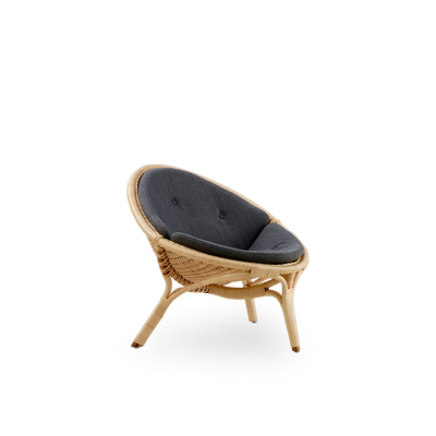 Side view of Rana lounge chair designed by Nanna Ditzel. Award-winning three-legged design, with fully woven seat, handcrafted from high-quality Indonesian rattan.