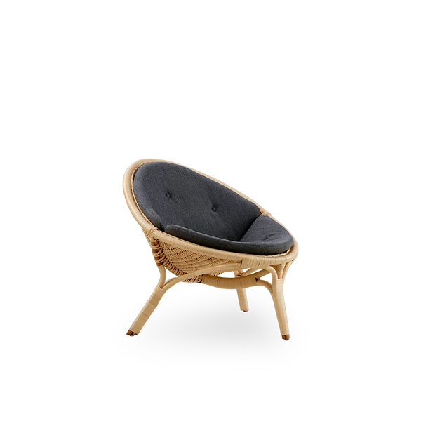 Side view of Rana lounge chair designed by Nanna Ditzel. Award-winning three-legged design, with fully woven seat, handcrafted from high-quality Indonesian rattan.
