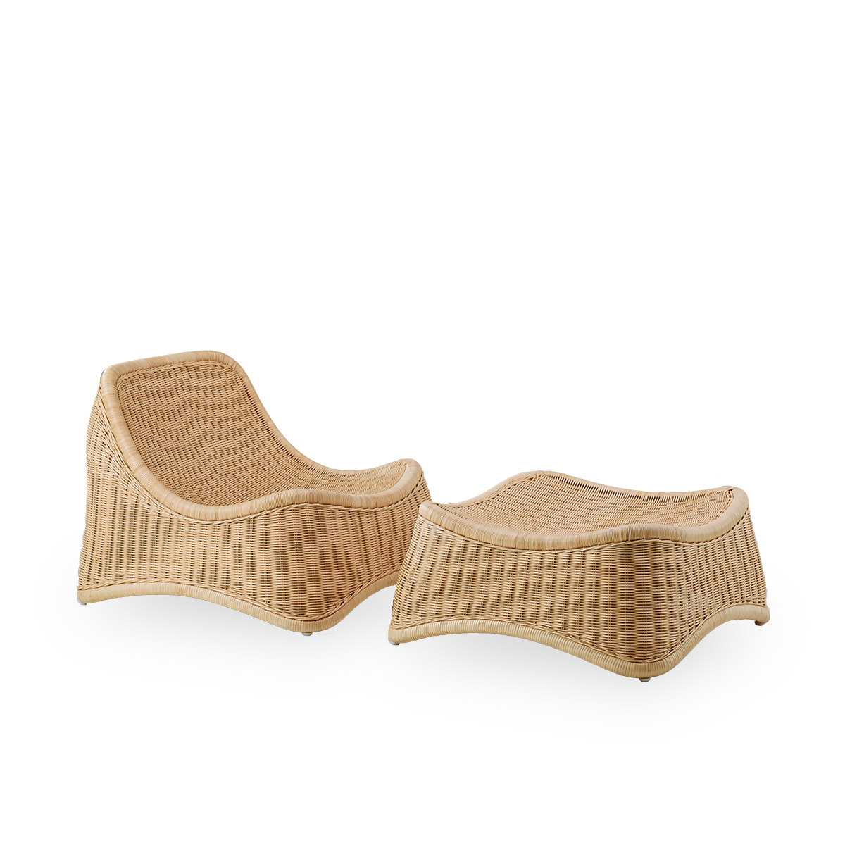 Side view of Chill Exterior lounge chair, a fully woven outdoor chair with a matching footstool designed by Nanna Ditzel. The chair has no armrests and is handcrafted from high quality Indonesian rattan.