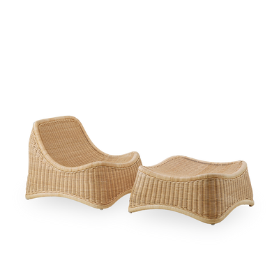 Side view of Chill Exterior lounge chair, a fully woven outdoor chair with a matching footstool designed by Nanna Ditzel. The chair has no armrests and is handcrafted from high quality Indonesian rattan.