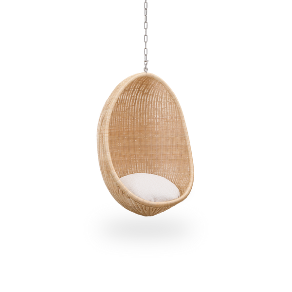 Side view of Hanging Egg Junior, the children's version of the iconic hammock chair designed by Nanna and Jørgen Ditzel. The round hanging chair is fully woven from high-quality Indonesian rattan and hangs in a metal chain.