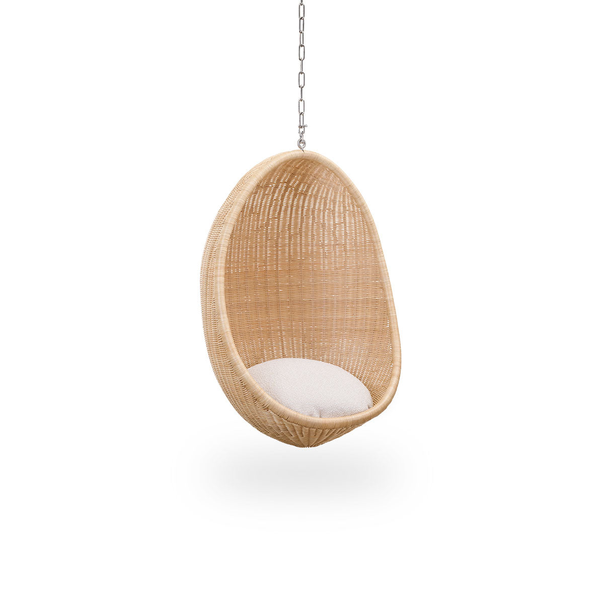 Side view of Hanging Egg Junior, the children's version of the iconic hammock chair designed by Nanna and Jørgen Ditzel. The round hanging chair is fully woven from high-quality Indonesian rattan and hangs in a metal chain.