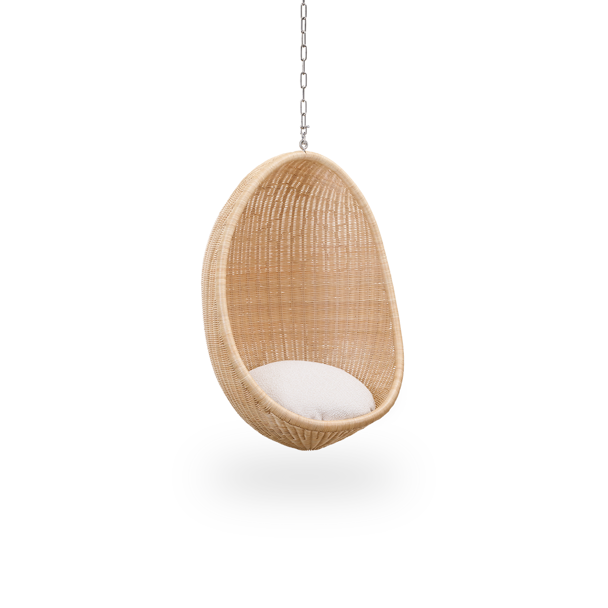 Side view of Hanging Egg Junior, the children's version of the iconic hammock chair designed by Nanna and Jørgen Ditzel. The round hanging chair is fully woven from high-quality Indonesian rattan and hangs in a metal chain.