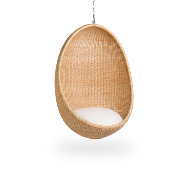 Side view of Hanging Egg, an iconic hammock chair designed by Nanna and Jørgen Ditzel. The round hanging chair is fully woven from high-quality Indonesian rattan and hangs in a metal chain.