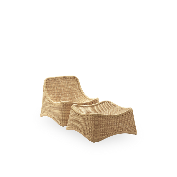 Side view of Chill Exterior lounge chair, a fully woven outdoor chair with a matching footstool designed by Nanna Ditzel. The chair has no armrests and is handcrafted from Alu-Rattan and ArtFibre.