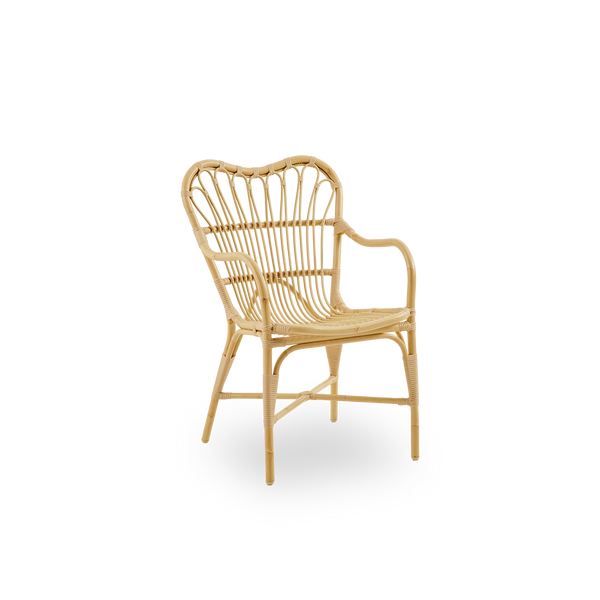 Side view of Margret outdoor dining chair with high wide backrest and curved armrests. Aluminium frame in natural rattan look with ArtFibre windings.  