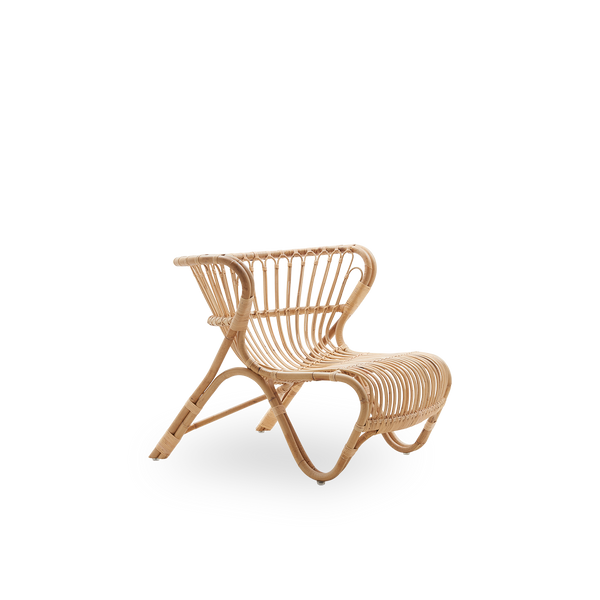 Side view of Fox lounge chair in natural rattan color designed by Viggo Boesen. Low curvy wicker lounge chair handcrafted from high-quality Indonesian rattan.