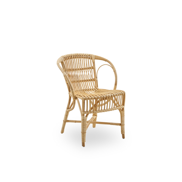 Side view of Robert dining chair in natural color designed by Robert W. Elegant wicker chair handcrafted from high-quality Indonesian rattan.