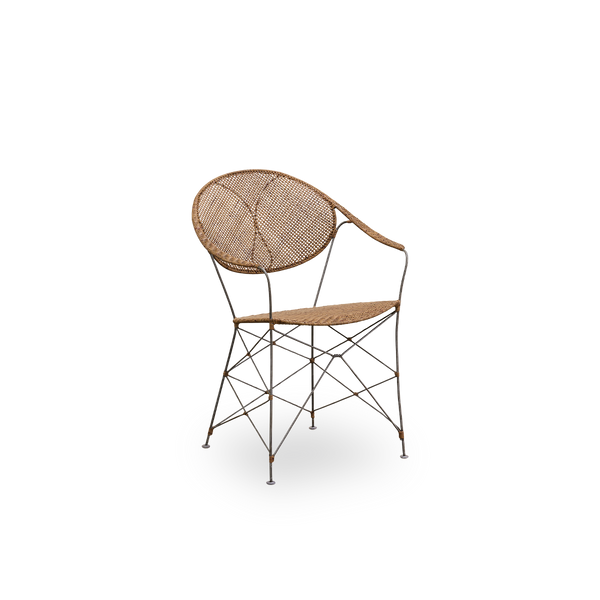 Side view of the Funky dining chair designed by Yuzuru Yamakawa. The chair has a steel frame with handwoven seat and backrest in high quality Indonesian rattan in Hazelnut color.