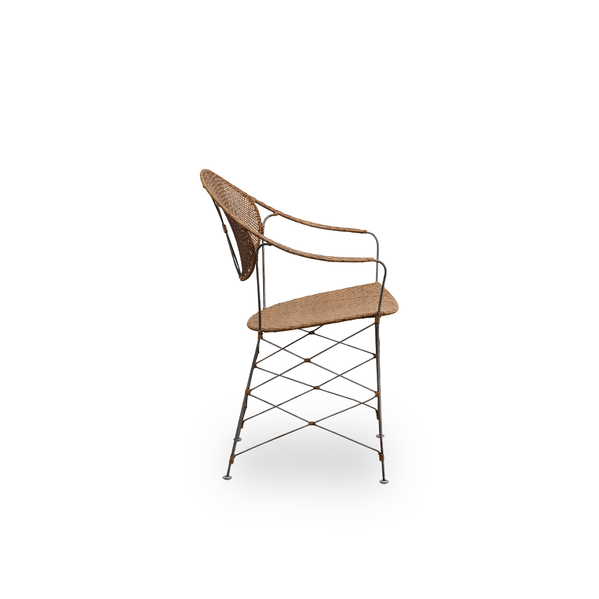 Plain side view of the Funky dining chair designed by Yuzuru Yamakawa. The chair has a steel frame with handwoven seat and backrest in high quality Indonesian rattan in Hazelnut color.