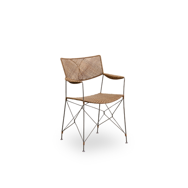 Side view of Rap dining chair designed by Yuzuru Yamakawa. Steel frame with seat and backrest handwoven with Indonesian rattan, lightweight chair combining Japanese design with traditional indonesian craftsmanship.