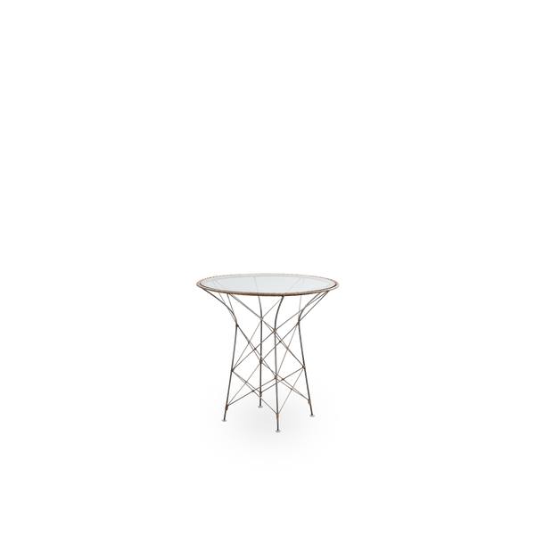 Side view of the Funky café table designed by Yuzuru Yamakawa. The table has a round glass table top and a steel frame which is handwoven with Indonesian rattan in Hazelnut color.